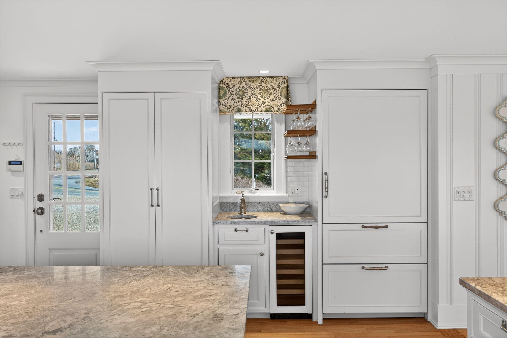 346 Morris Island Road Chatham, MA 02633 - Photo 12 of 33 a kitchen with white cabinets and window