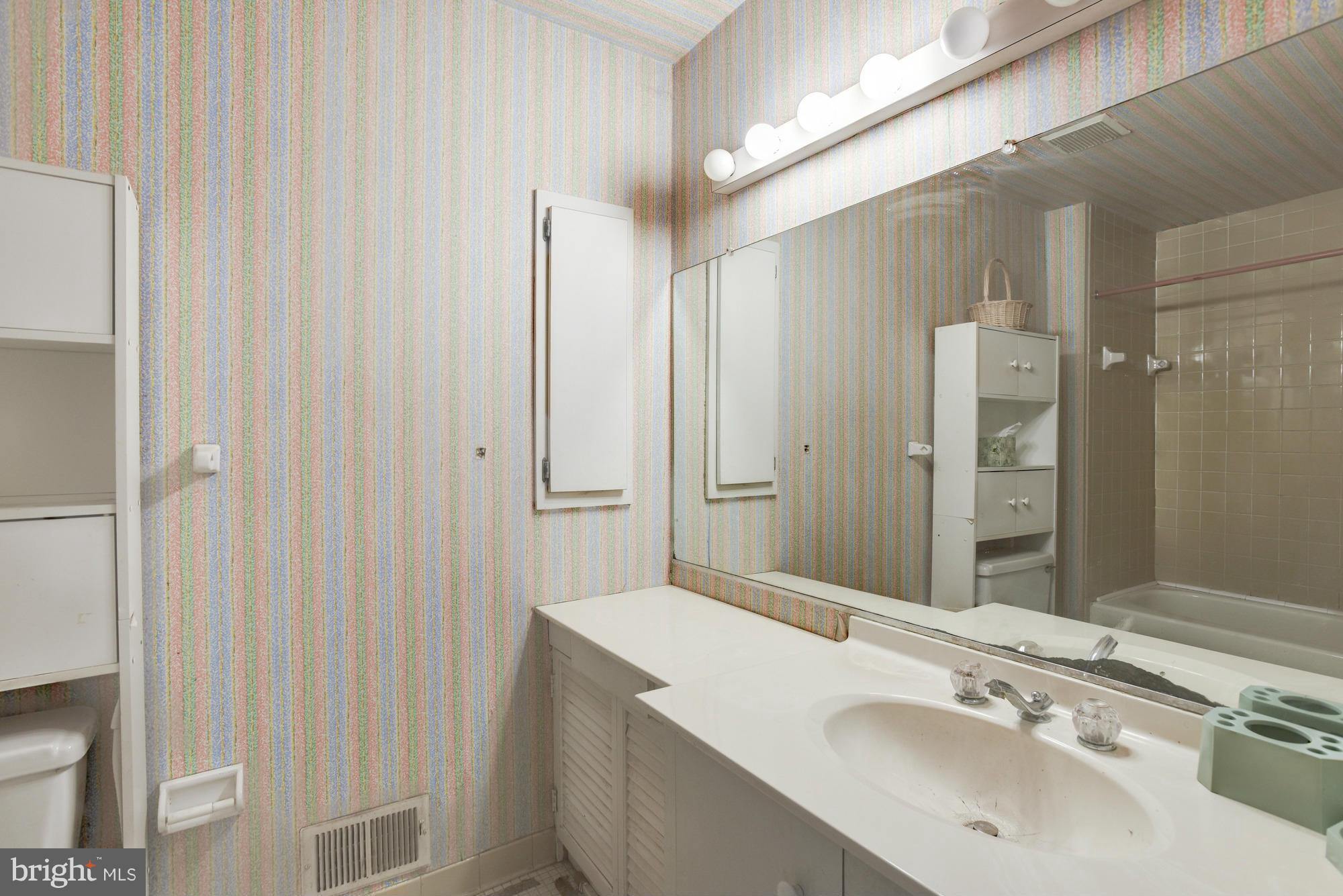 4452 Roland Springs Drive Baltimore, MD 21210 - Photo 20 of 29 a bathroom with a sink and a mirror