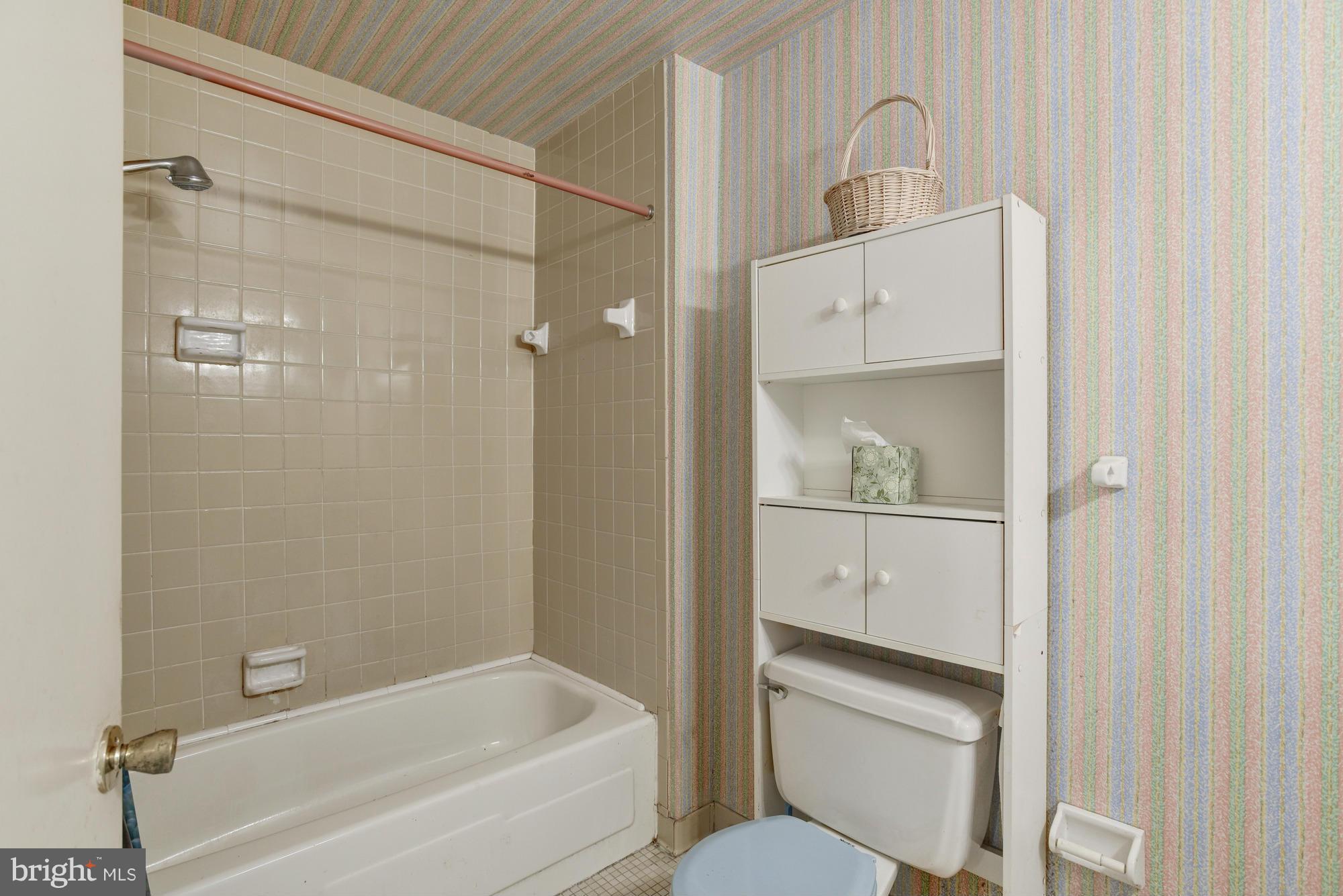 4452 Roland Springs Drive Baltimore, MD 21210 - Photo 21 of 29 a bathroom with a shower a sink and a toilet