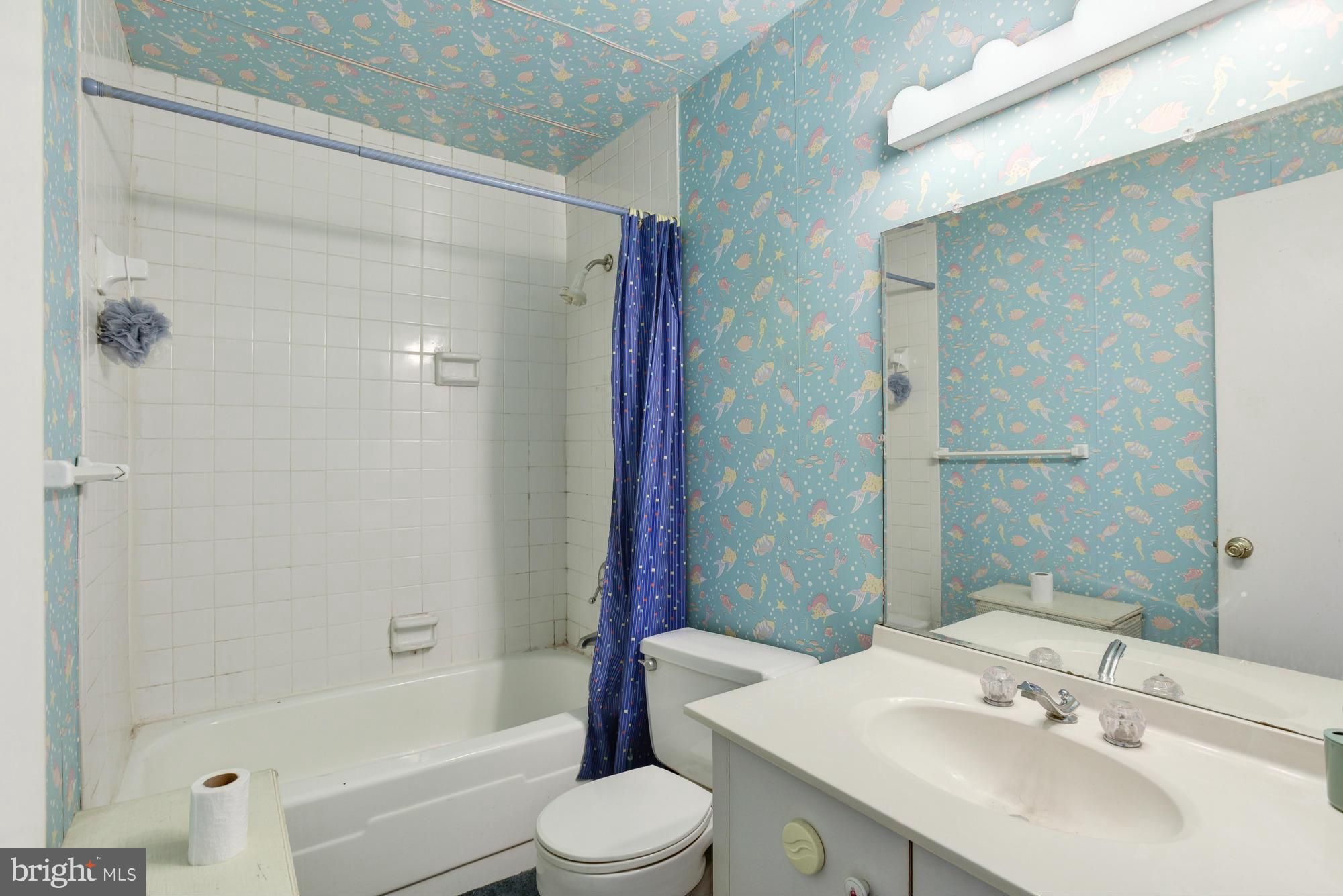4452 Roland Springs Drive Baltimore, MD 21210 - Photo 23 of 29 a bathroom with a sink toilet and shower