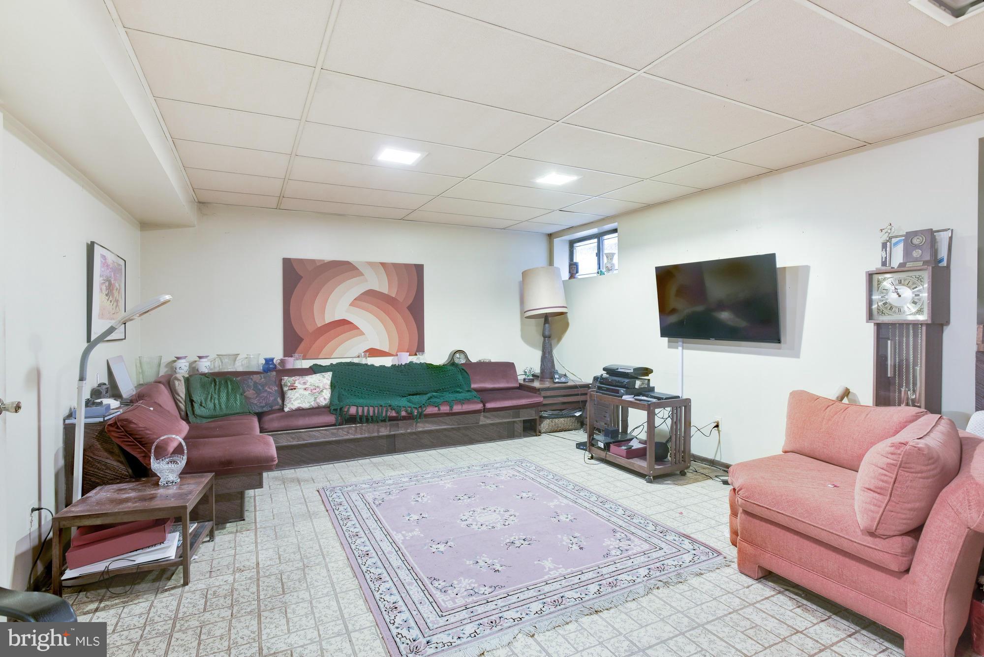 4452 Roland Springs Drive Baltimore, MD 21210 - Photo 24 of 29 a living room with furniture and a flat screen tv