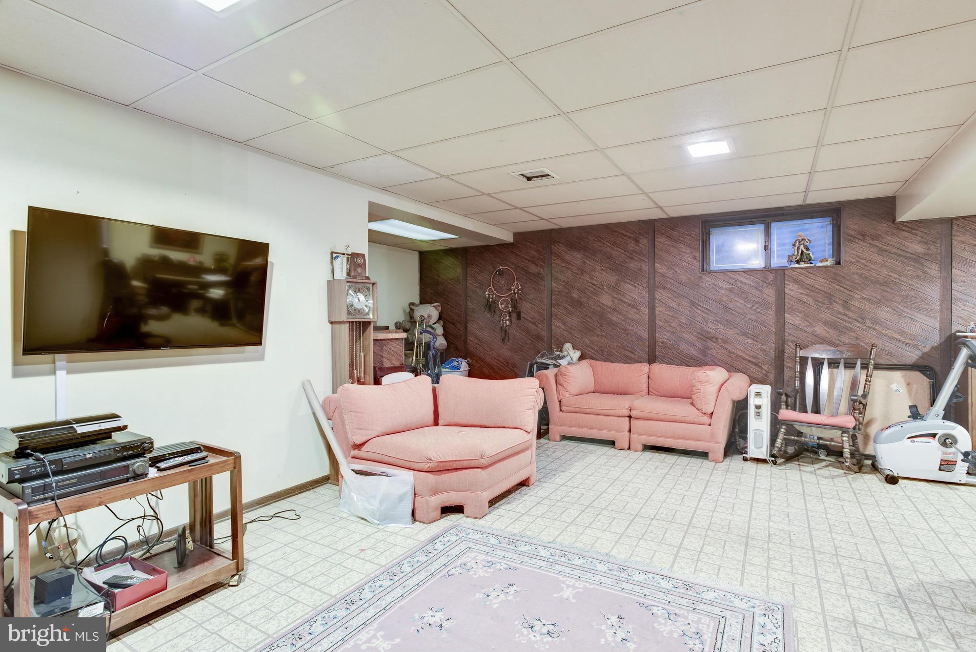 4452 Roland Springs Drive Baltimore, MD 21210 - Photo 25 of 29 a living room with furniture and a flat screen tv