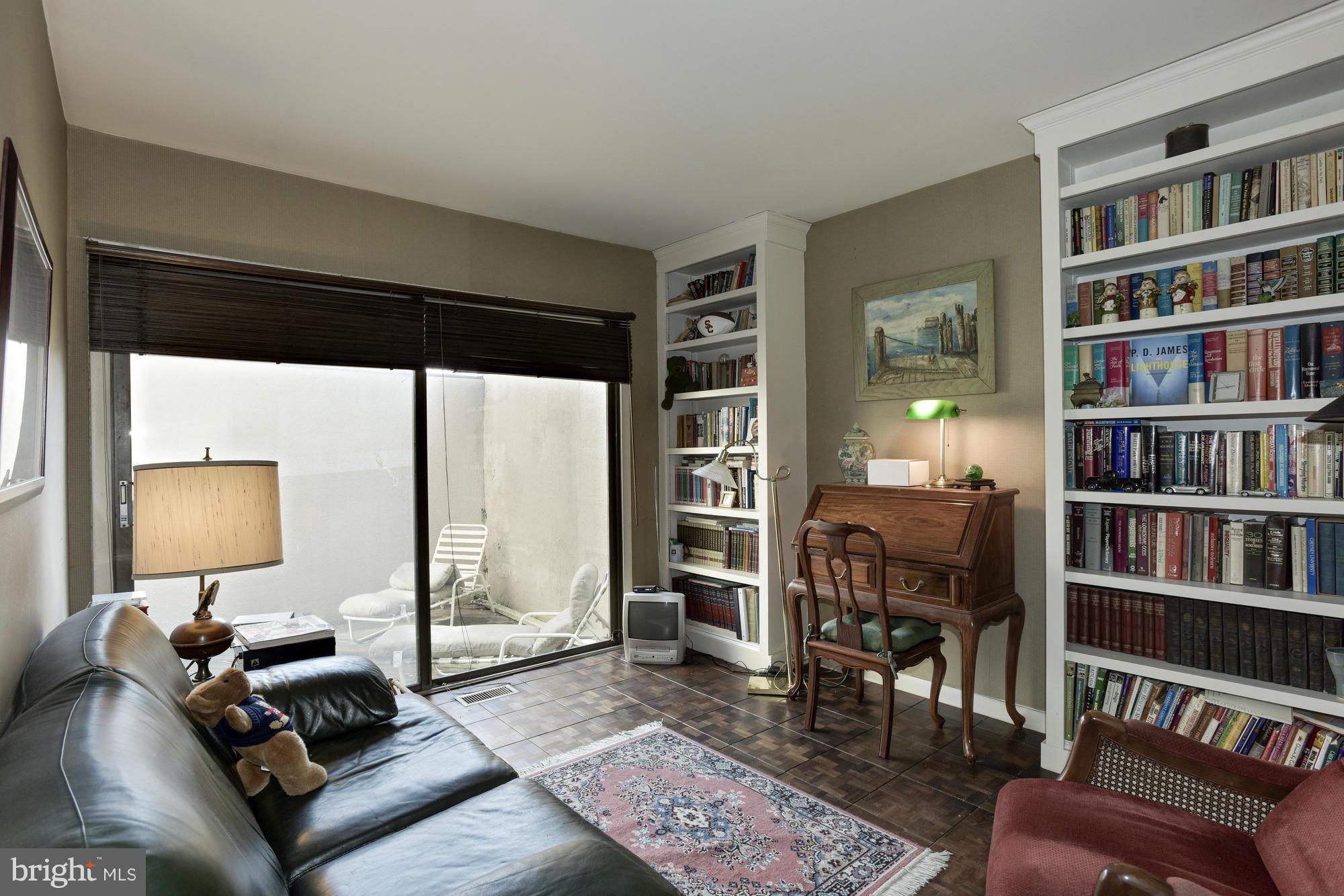 4452 Roland Springs Drive Baltimore, MD 21210 - Photo 5 of 29 a living room with furniture and a book shelf