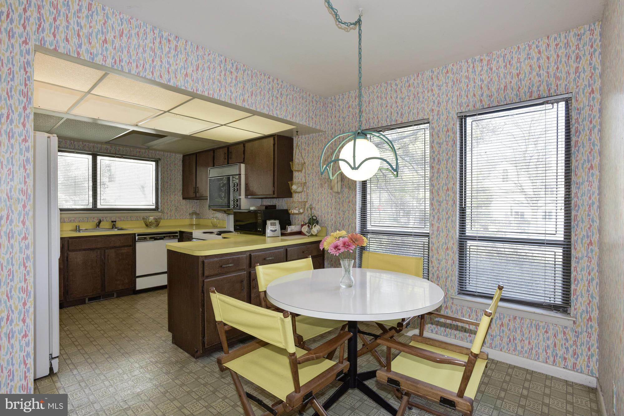 4452 Roland Springs Drive Baltimore, MD 21210 - Photo 8 of 29 a kitchen with a table and chairs in it