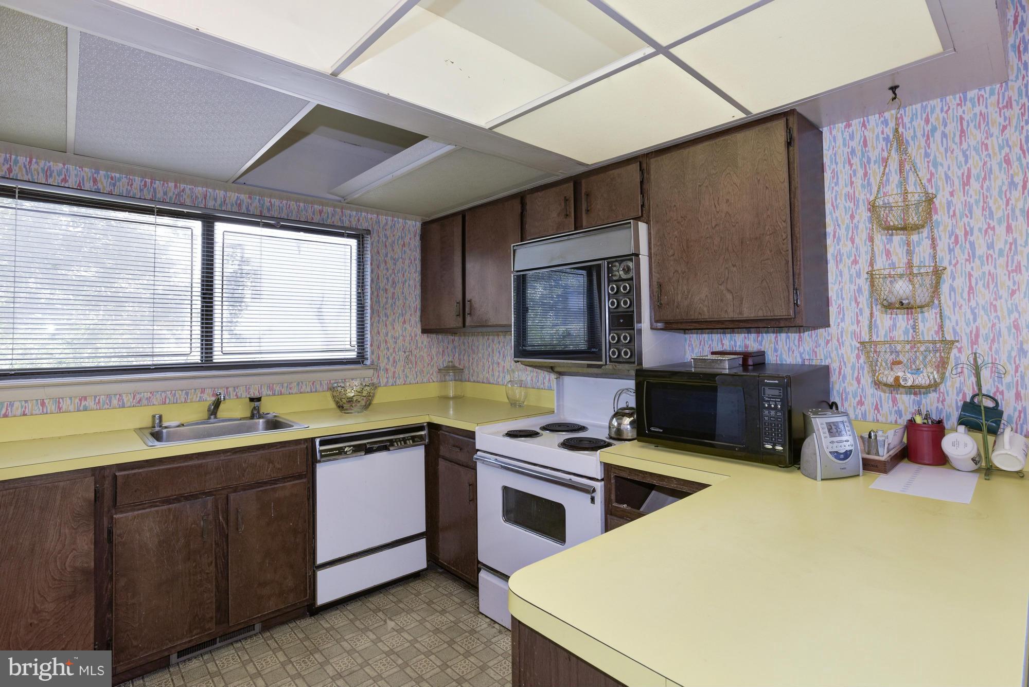 4452 Roland Springs Drive Baltimore, MD 21210 - Photo 9 of 29 a kitchen that has a sink and a stove top oven