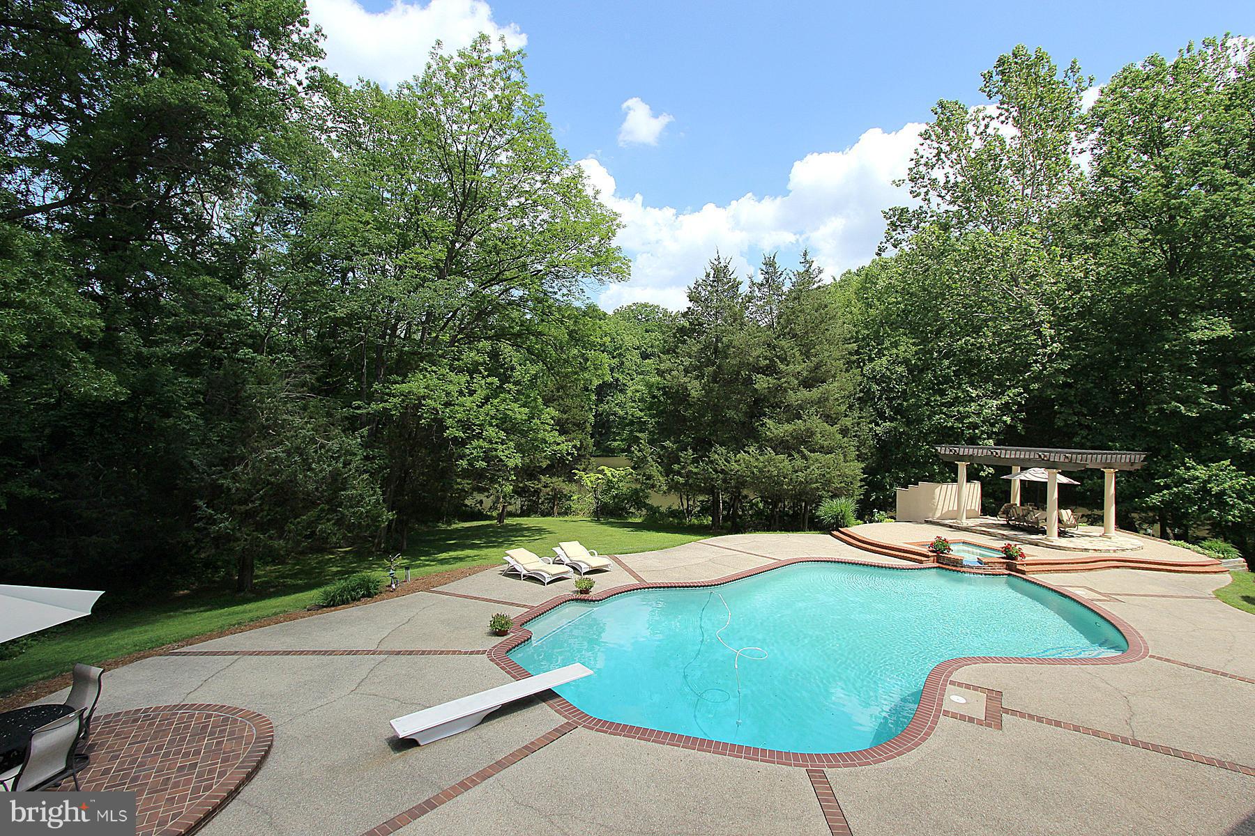 8823 Brook Road McLean, VA 22102 - Photo 24 of 30 a view of a swimming pool with a patio and a yard