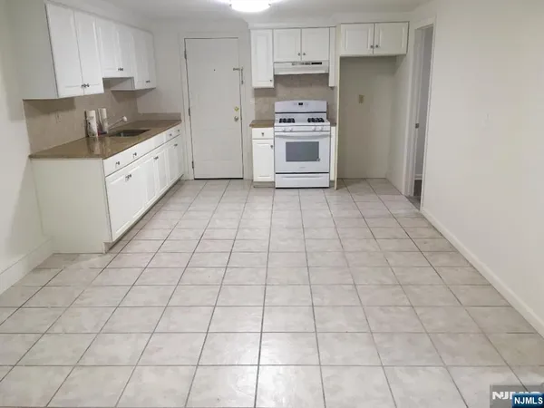 a kitchen with stainless steel appliances a sink and cabinets