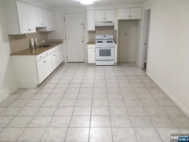a kitchen with stainless steel appliances a sink and cabinets