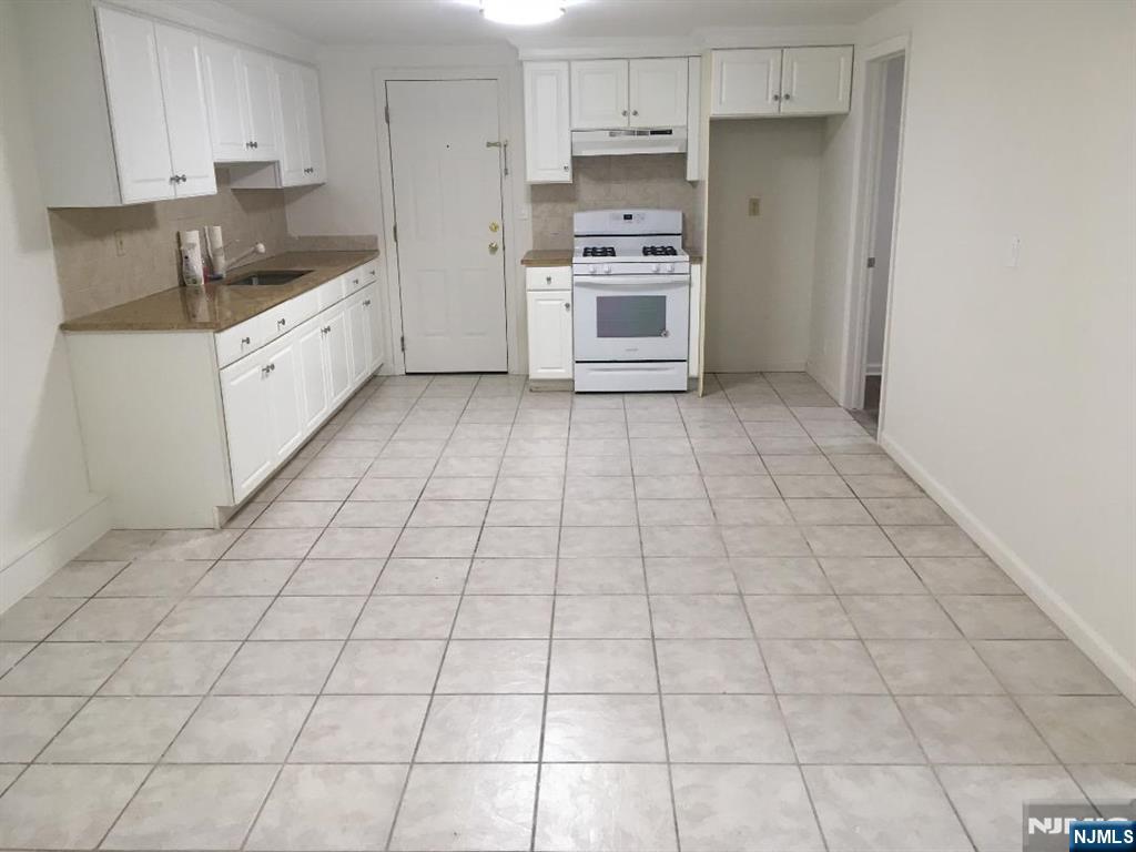 547 High Mountain Road, Unit 3 North Haledon, NJ 07508 - Photo 3 of 7 a kitchen with stainless steel appliances a sink and cabinets