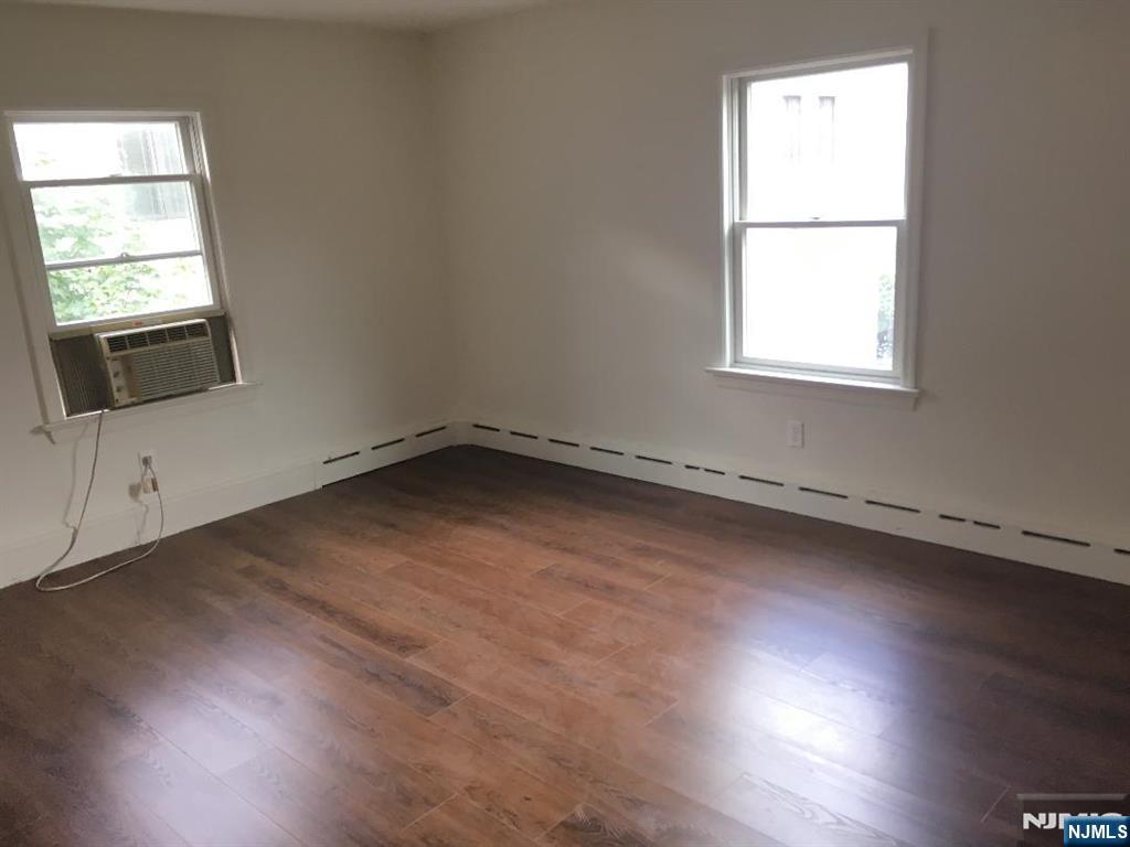 547 High Mountain Road, Unit 3 North Haledon, NJ 07508 - Photo 4 of 7 an empty room with wooden floor and windows