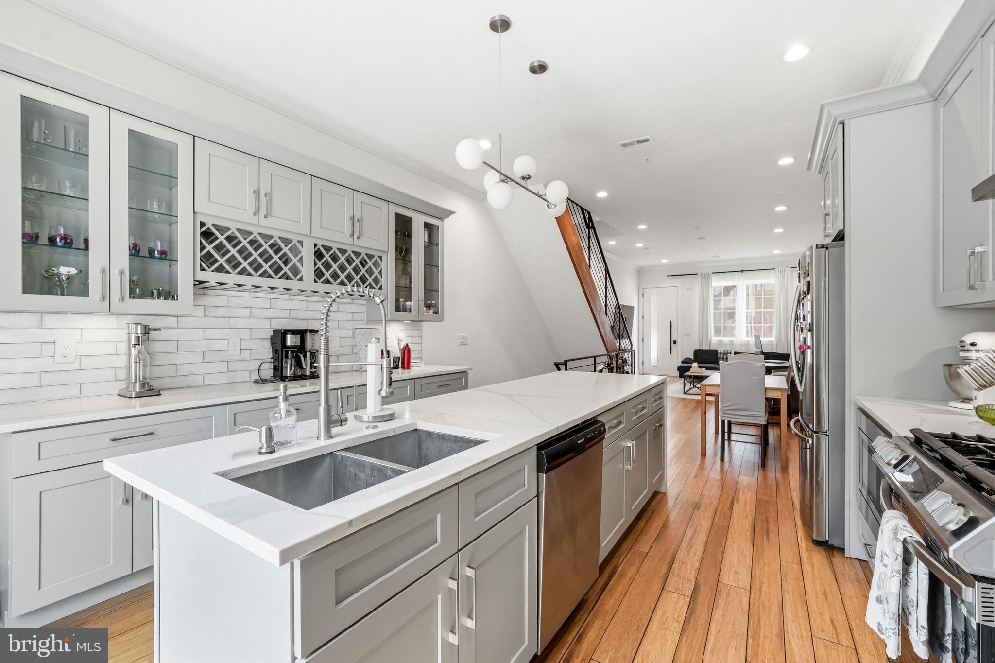 2604 Reed Street Philadelphia, PA 19146 - Photo 5 of 45 a kitchen with a sink stove and cabinets