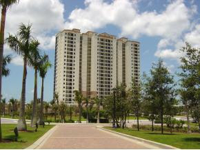 1065 Borghese Lane, Unit 704 Naples, FL 34114 - Photo 1 of 5 a view of a building with a yard