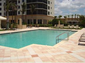 1065 Borghese Lane, Unit 704 Naples, FL 34114 - Photo 4 of 5 a swimming pool with outdoor seating and yard