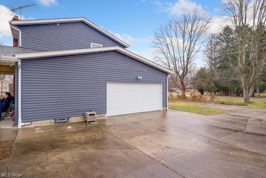 4618 South Arlington Road Uniontown, OH 44685 - Photo 4 of 31 View of home's exterior featuring a garage