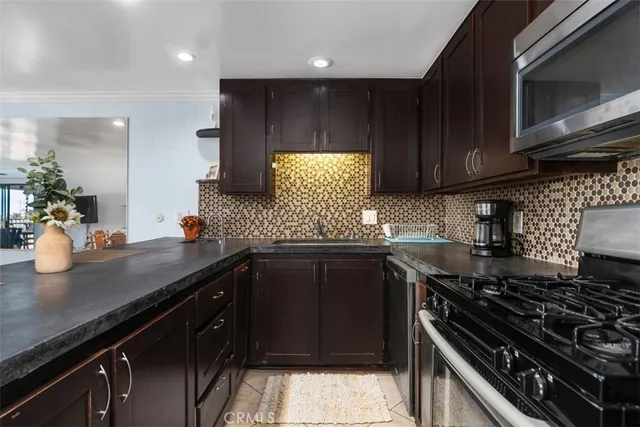 a kitchen with wooden cabinets and a stove top oven