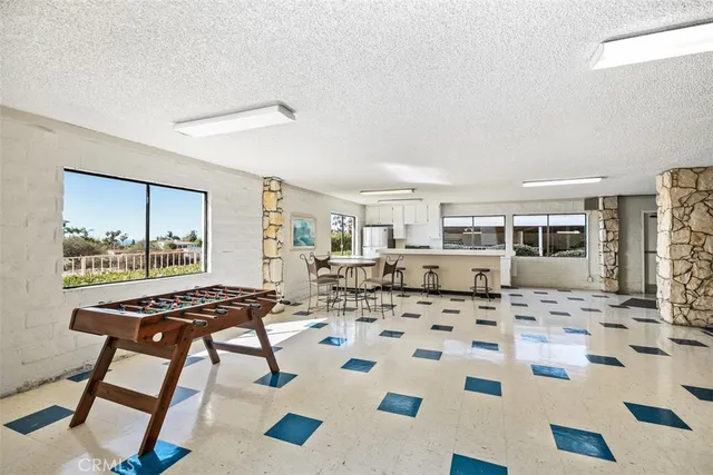 a view of a swimming pool and chairs in the patio