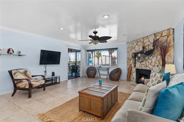 a living room with furniture a flat screen tv and a fireplace