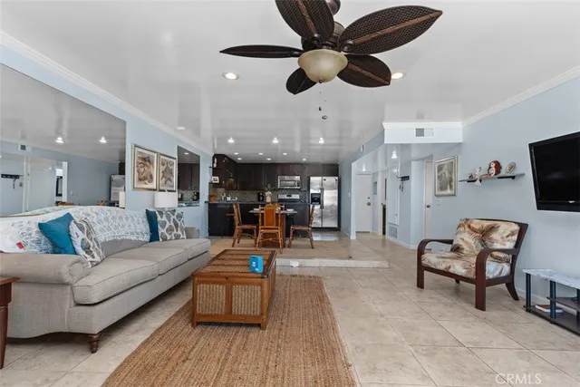 a living room with furniture and a view of kitchen