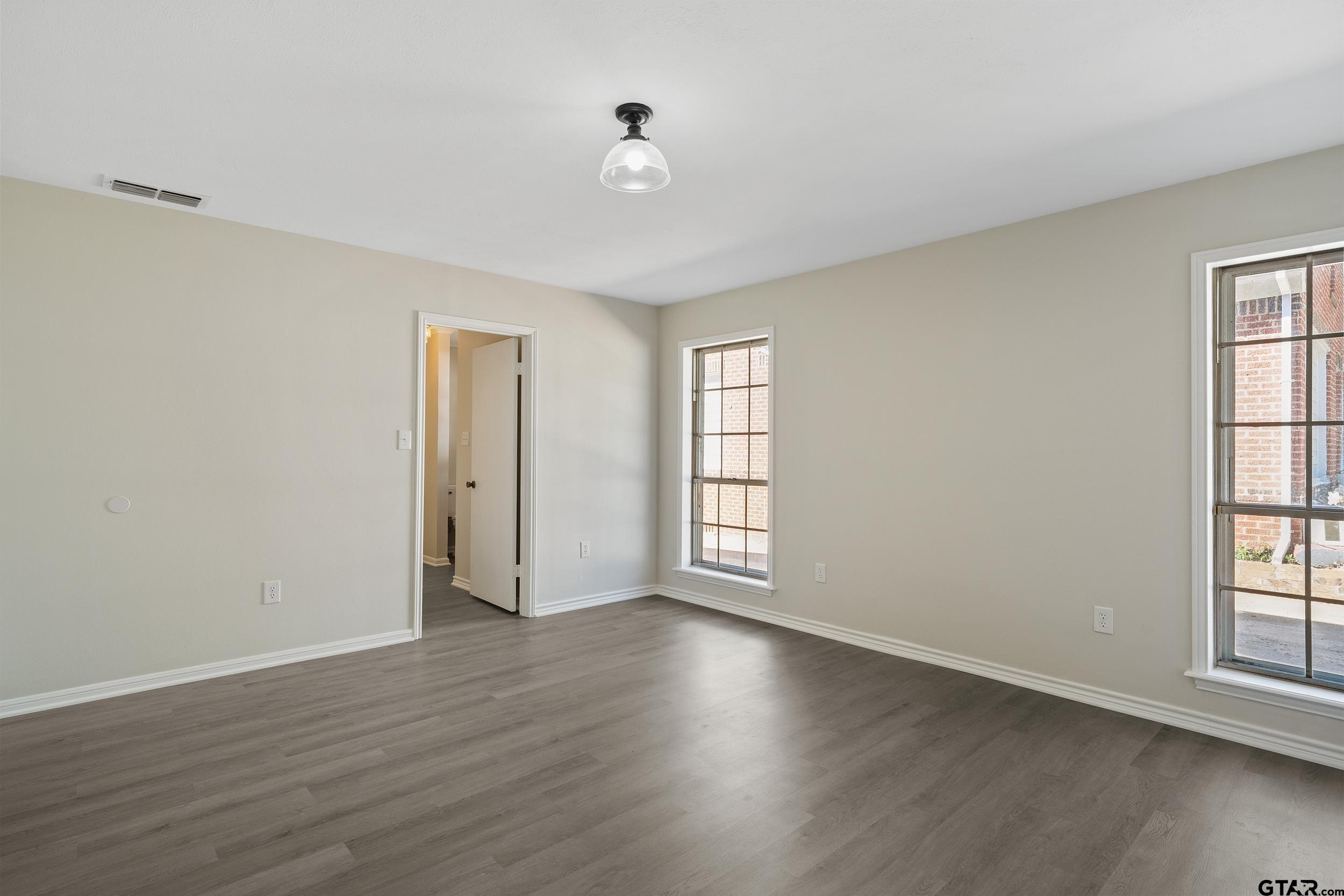 238 North Main Street Rusk, TX 75785 - Photo 20 of 42 a view of an empty room with wooden floor and a window