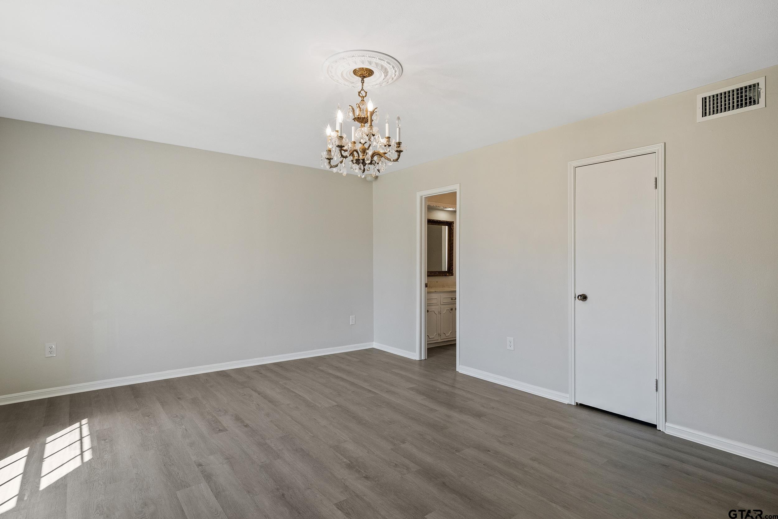238 North Main Street Rusk, TX 75785 - Photo 33 of 42 a view of a chandelier in big room and wooden floor