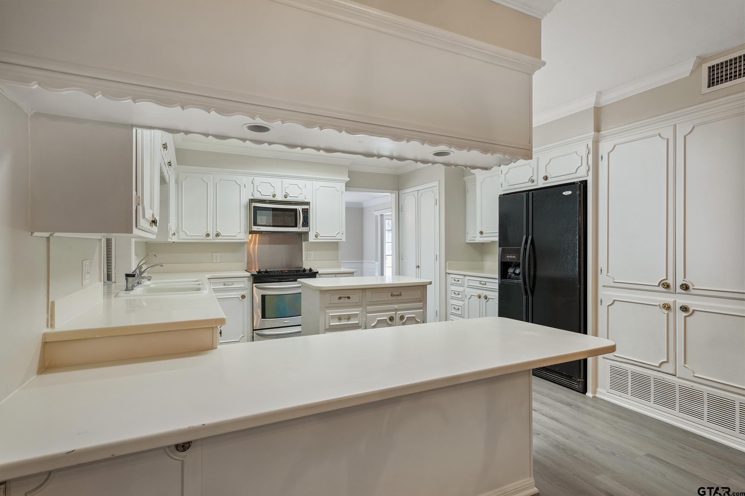 238 North Main Street Rusk, TX 75785 - Photo 37 of 42 a kitchen with stainless steel appliances a refrigerator and a stove top oven