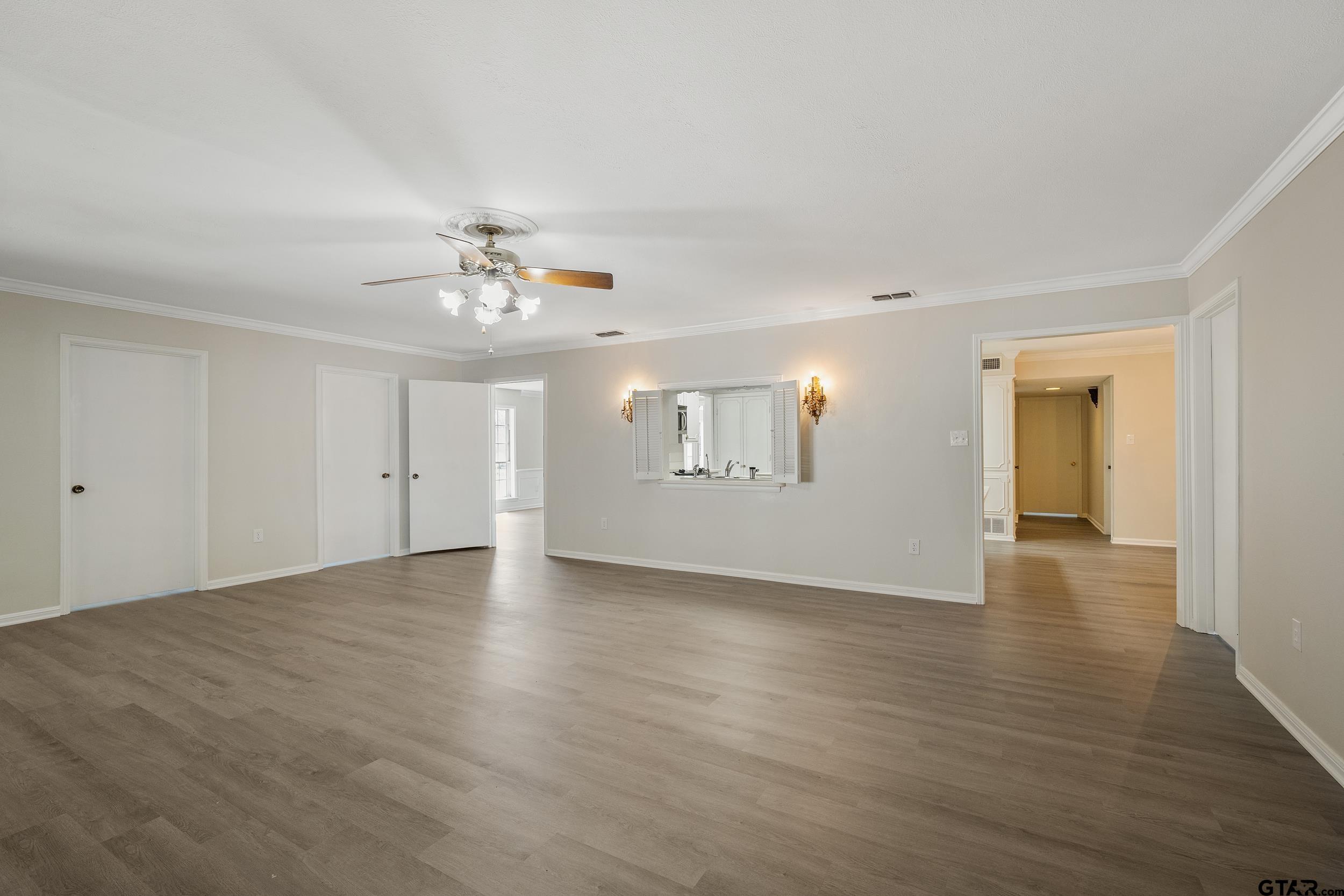 238 North Main Street Rusk, TX 75785 - Photo 41 of 42 a view of a livingroom with wooden floor and a ceiling fan