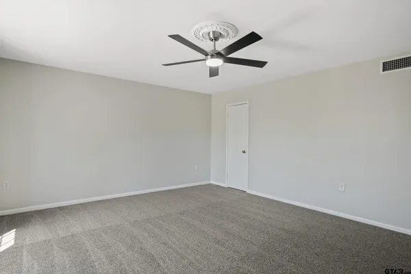 a view of a big room with ceiling fan