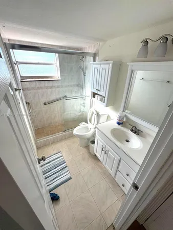 a bathroom with a double vanity sink toilet and a mirror