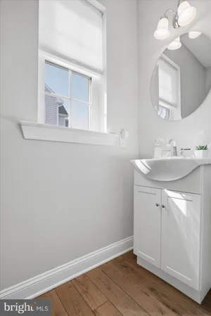 a bathroom with a sink vanity and a mirror