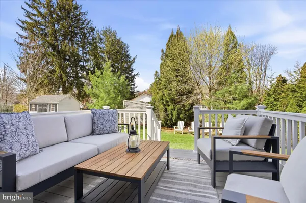a roof deck with couches and wooden fence