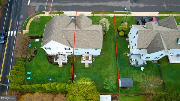 an aerial view of multiple houses with yard