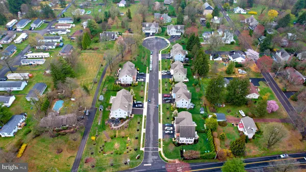 an aerial view of a house with garden space and a street view