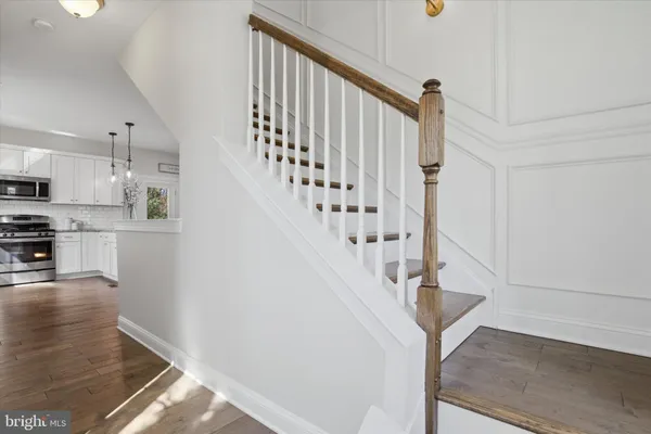 a view of entryway and hall with wooden floor