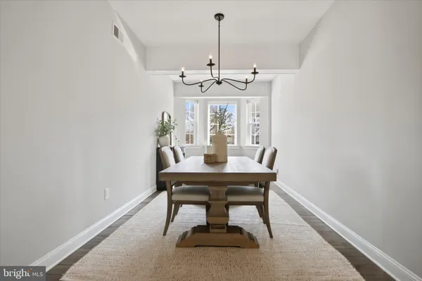 a view of a dining room with a table and chairs
