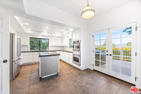 a kitchen with stainless steel appliances granite countertop a sink and a stove