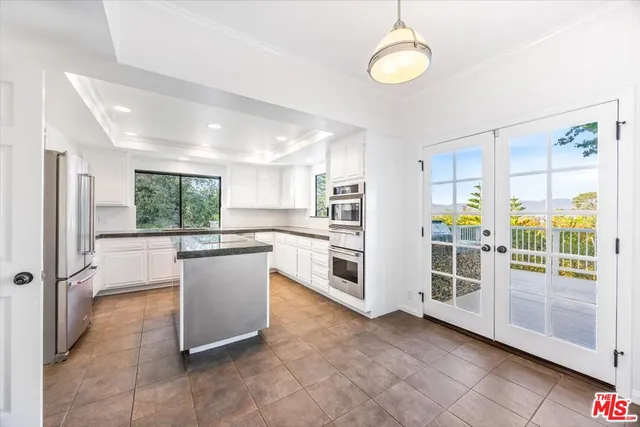 a kitchen with stainless steel appliances granite countertop a sink and a stove