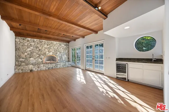 a kitchen with granite countertop white cabinets and appliances