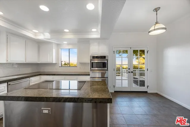 a spacious bedroom with a large bed and a large window