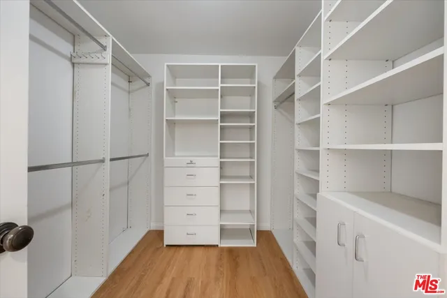 a spacious bedroom with a bed a fireplace and a window