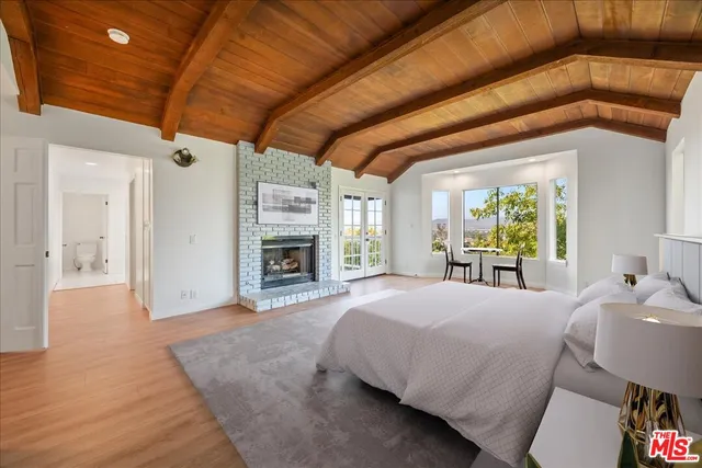 a view of an empty room with window and fire place
