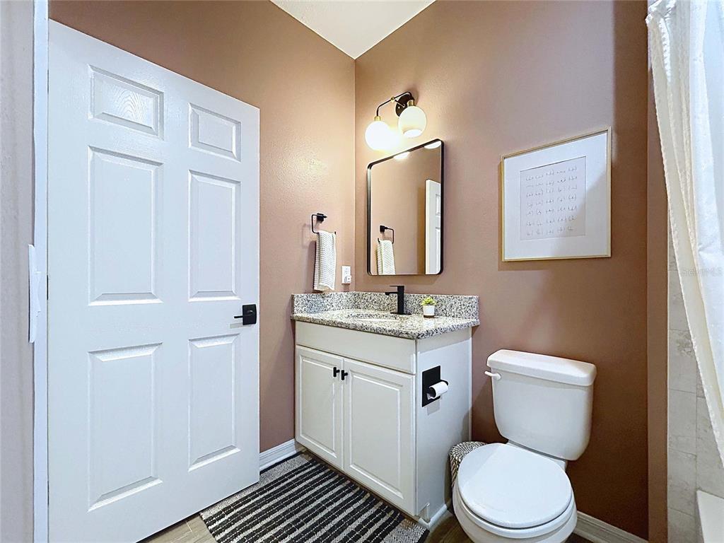 18078 Romanesque Court Spring Hill, FL 34610 - Photo 52 of 81 a bathroom with a toilet a sink and mirror