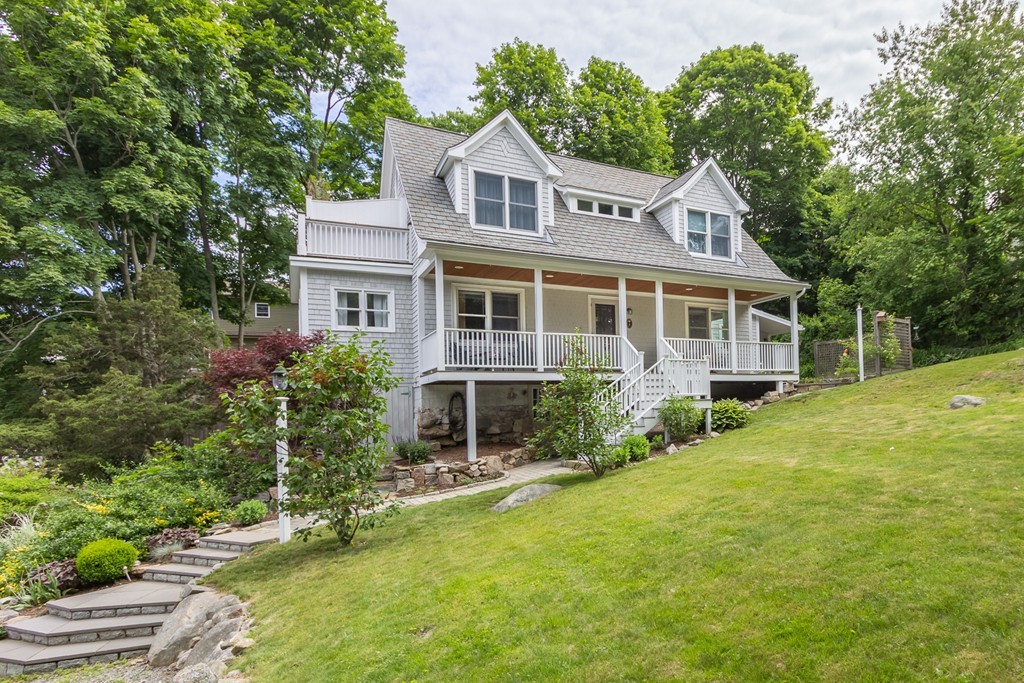 a front view of a house with yard and green space