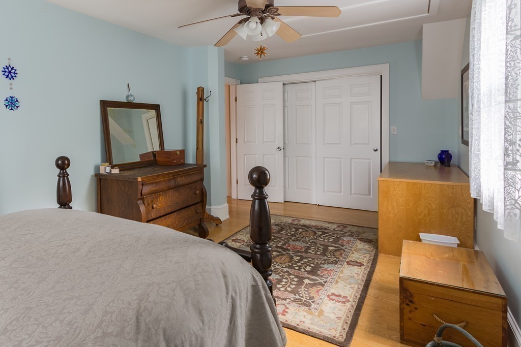 4 Echo Avenue Gloucester, MA 01930 - Photo 21 of 26 a bedroom with a bed and a chandelier