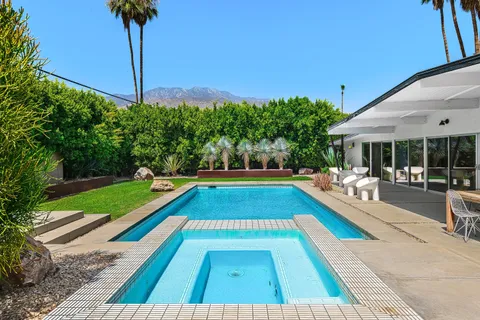 a view of swimming pool with lounge chair