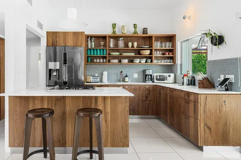 a kitchen with stainless steel appliances granite countertop a refrigerator and a stove top oven