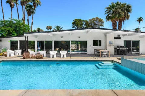 a view of swimming pool with a patio