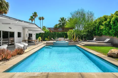 a view of a backyard with a table and chairs