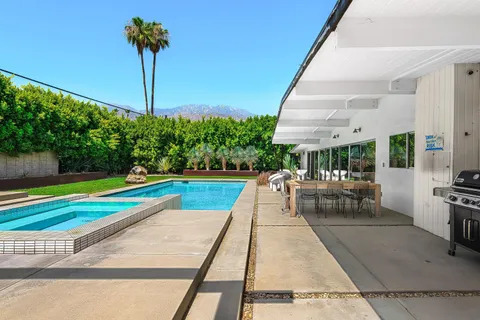 a view of a swimming pool with a yard