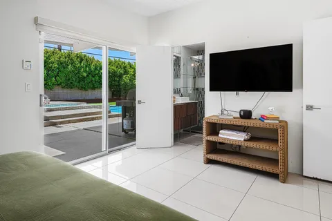 a bedroom with a bed chair and a large window