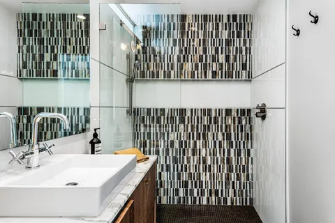 a bathroom with a sink a toilet and shower